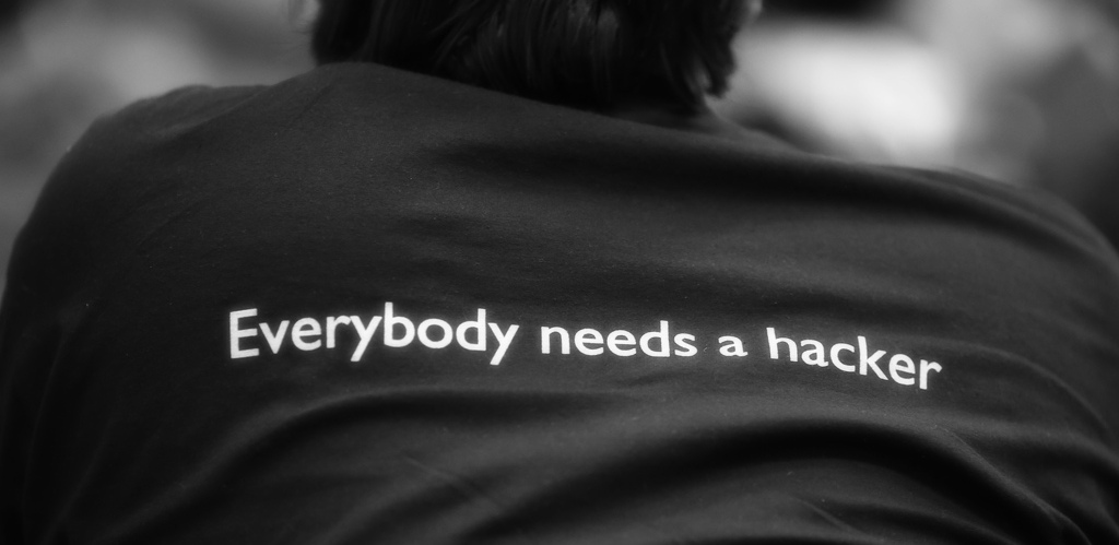 "Everbody needs a hacker" written on a shirt at FOSDEM 2013